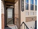 Dark brown front door with a brick exterior and black railing at 372 Provenance Dr, Sandy Springs, GA 30328