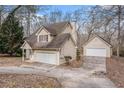 Tan house with a two-car garage and detached workshop at 80 Valley Dr, Stockbridge, GA 30281