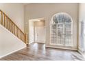 Two-story foyer with hardwood floors, neutral walls, and an arched window at 80 Valley Dr, Stockbridge, GA 30281