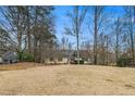 Lovely yellow house with a large front lawn and mature trees at 4741 W Lake Se Dr, Conyers, GA 30094