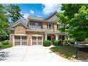 Two-story brick home with a large front yard, two-car garage, and a covered porch at 5540 Fords Crossing Nw Ct, Acworth, GA 30101