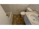 Standard bathroom featuring a toilet, sink and shower/tub at 4990 Windsor Downs Dr, Decatur, GA 30035