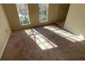 View of sunlit living room with light streaming in through the windows at 4990 Windsor Downs Dr, Decatur, GA 30035
