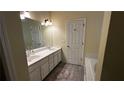 Clean bathroom with double vanity and bathtub at 2817 Quince Nw Ln, Acworth, GA 30101