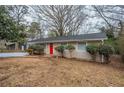 House exterior view, featuring a red front door and landscaping at 1728 W Austin Rd, Decatur, GA 30032