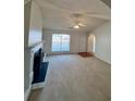 Bright and airy living room featuring a fireplace, large windows, and an entrance to the hallway at 3745 Hudson Ct, Rex, GA 30273