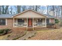 Inviting front porch with orange door and white railings at 3870 N Shelby N Ln, Douglasville, GA 30135