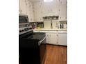 Kitchen with white cabinets, stainless steel appliances at 4194 Sugarberry Sw Ln, Lilburn, GA 30047