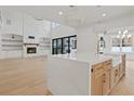 Modern kitchen with a large island, white cabinets, and a farmhouse sink at 2910 Caney Parc Way, Cumming, GA 30041