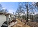 Expansive backyard featuring a deck, steps and pathway leading to natural woodlands at 1412 Dallas Sw Cir, Marietta, GA 30064