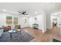 Open-concept living room featuring hardwood floors, neutral tones, and seamless flow to other areas of the home at 1626 Rice Rd, Lithonia, GA 30058