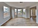 Bright living room with bay windows and wood-look floors at 4668 Snap Creek Ln, Decatur, GA 30035