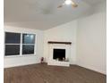 Bright living room featuring a corner fireplace and wood-look flooring at 11110 Mortons Xing, Alpharetta, GA 30022