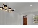 Bright entryway with wood floors and modern chandelier at 350 Sugarview Rd, Sugar Hill, GA 30518