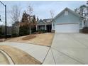 House exterior showcasing a light blue facade and a neatly manicured lawn at 4338 Braden Nw Ln, Kennesaw, GA 30144