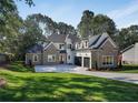 Brick home with a two-car garage and landscaped lawn at 754 Moon Road, Lawrenceville, GA 30046