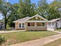 Renovated brick home with a front porch and landscaped yard at 1546 Richland Sw Rd, Atlanta, GA 30311