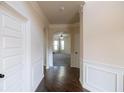 Entryway with hardwood floors, white wainscoting, and arched openings at 3535 Clarecastle Dr, Buford, GA 30519
