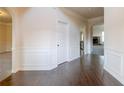 Entryway with hardwood floors, white wainscoting, and arched openings at 3535 Clarecastle Dr, Buford, GA 30519