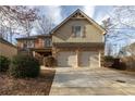 Two-story home with brick and vinyl siding, plus a two-car garage and driveway at 3535 Clarecastle Dr, Buford, GA 30519