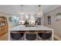 Open concept kitchen with white cabinets, quartz countertops, and island seating at 100 Verlaine Nw Pl, Atlanta, GA 30327