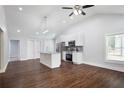 Modern kitchen with white cabinets, granite island, and dark hardwood floors at 1482 Andrews Nw St, Atlanta, GA 30314