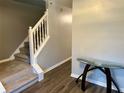 Entryway with staircase, glass-top table, and wood-look floors at 3877 Oakman Pl, Fairburn, GA 30213