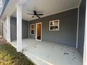 Covered back porch with white columns and ceiling fan at 2259 Old Yorkville Rd, Dallas, GA 30157