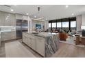 Modern kitchen with an island featuring marble countertops, stainless steel appliances, and hardwood flooring at 2520 Peachtree Nw Rd # 1202, Atlanta, GA 30305