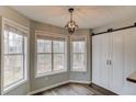 Eat-in kitchen area with multiple windows offering natural light and a barn door at 93 Highway 81, Oxford, GA 30054