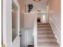 Bright and spacious entryway with stairs leading upstairs and a spiral staircase at 93 Highway 81, Oxford, GA 30054