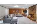 Well-lit living room showcasing a stone fireplace, wood paneling, and comfortable seating at 1619 Ridgeview Nw Dr, Conyers, GA 30012