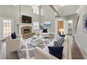 Bright living room with vaulted ceilings, fireplace, modern decor, and plush seating at 8270 Mossybrook Ln, Douglasville, GA 30135