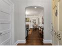 View of living room through an arched entryway, showcasing the hardwood floors and inviting fireplace at 3495 Habersham Nw Rd, Atlanta, GA 30305