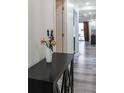 Stylish hallway featuring a mirrored console table and fresh flowers at 1280 W Peachtree Nw St # 2813, Atlanta, GA 30309