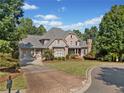 Beautiful brick home with a three car garage, long driveway and mature landscaping at 149 Cedar Woods Trl, Canton, GA 30114