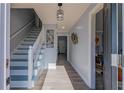 Welcoming entryway featuring hardwood floors, a staircase, and elegant lighting fixtures at 6432 Phillips Pl, Lithonia, GA 30058