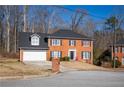 Attractive brick two-story home with a well-manicured front yard and an attached two-car garage at 6432 Phillips Pl, Lithonia, GA 30058