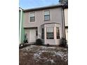 Two-story townhouse with gray siding, a bay window, and a small front yard at 1023 Thornwoode Ln, Stone Mountain, GA 30083