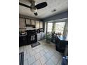 Galley kitchen with black appliances and gray cabinets at 1023 Thornwoode Ln, Stone Mountain, GA 30083