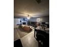 Living room with a fireplace, brown couch, and tile floors at 1023 Thornwoode Ln, Stone Mountain, GA 30083