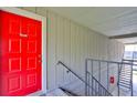 Red front door and exterior stairs leading to apartment entrance at 1414 Branch Dr, Tucker, GA 30084