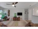 Living room with ceiling fan, television, and view to another room at 1414 Branch Dr, Tucker, GA 30084