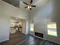 Two-story living room with fireplace and kitchen view at 45 Heyman Dr, Covington, GA 30016