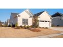 A view of the front of the home, highlighting the lawn and landscaping at 412 Southbridge Pass, Peachtree City, GA 30269