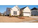 Light brick home featuring a well-maintained front yard and a two-car garage at 412 Southbridge Pass, Peachtree City, GA 30269