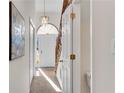 Light-filled hallway with neutral walls and access to powder room at 4580 Kinsdale Sw Dr, Mableton, GA 30126