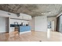 Modern kitchen with stainless steel appliances and breakfast bar at 950 W Peachtree Nw St # 812, Atlanta, GA 30309