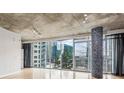 Light-filled living room featuring hardwood floors and floor-to-ceiling windows at 950 W Peachtree Nw St # 812, Atlanta, GA 30309