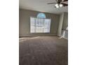 Spacious living room featuring a large window, carpeted floors, and a ceiling fan at 10561 Aspenwood Ct, Jonesboro, GA 30238